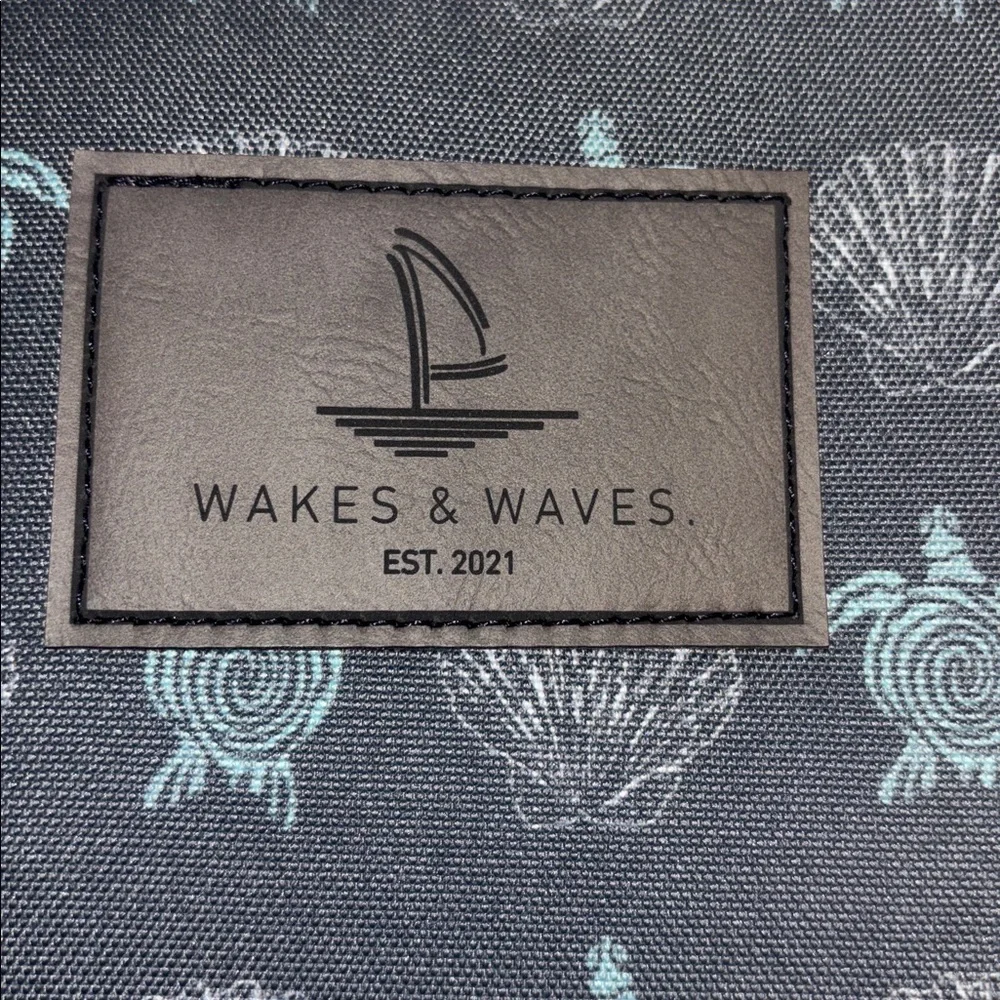WAKES & WAVES BLUE WRISTLET WITH TURTLE DESIGN WATERPROOF CANVAS LIKE MATERIAL